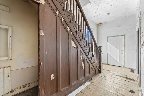 a view of an empty room with a bathroom and a sink