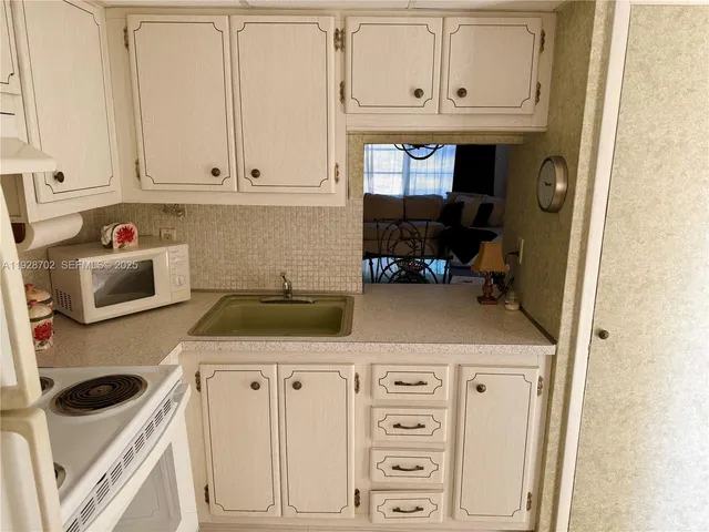 a kitchen with a stove top oven and cabinets