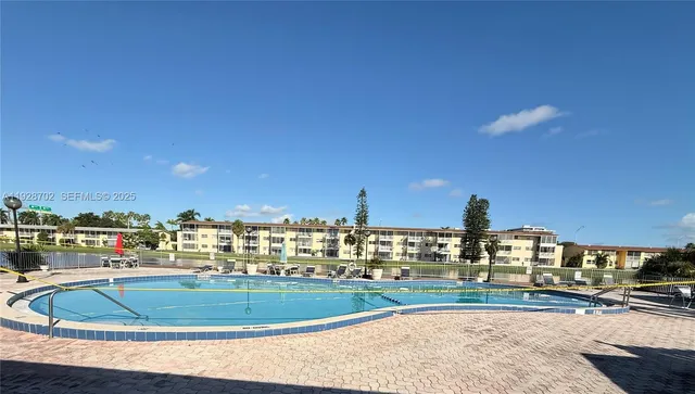 a view of a swimming pool with an outdoor seating