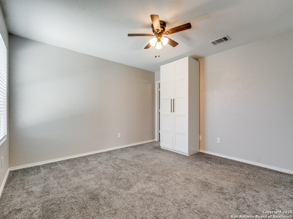 31593 Nimbus Drive Bulverde, TX 78163 - Photo 11 of 30 an empty room with closet and a chandelier fan