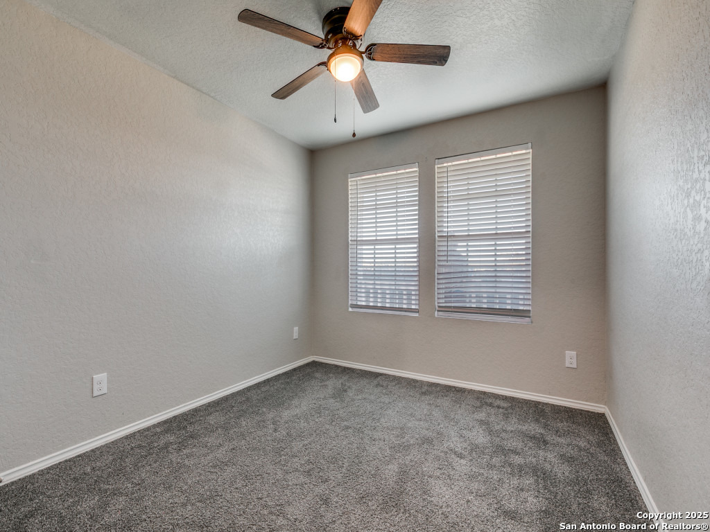 31593 Nimbus Drive Bulverde, TX 78163 - Photo 13 of 30 an empty room with a window and a fan