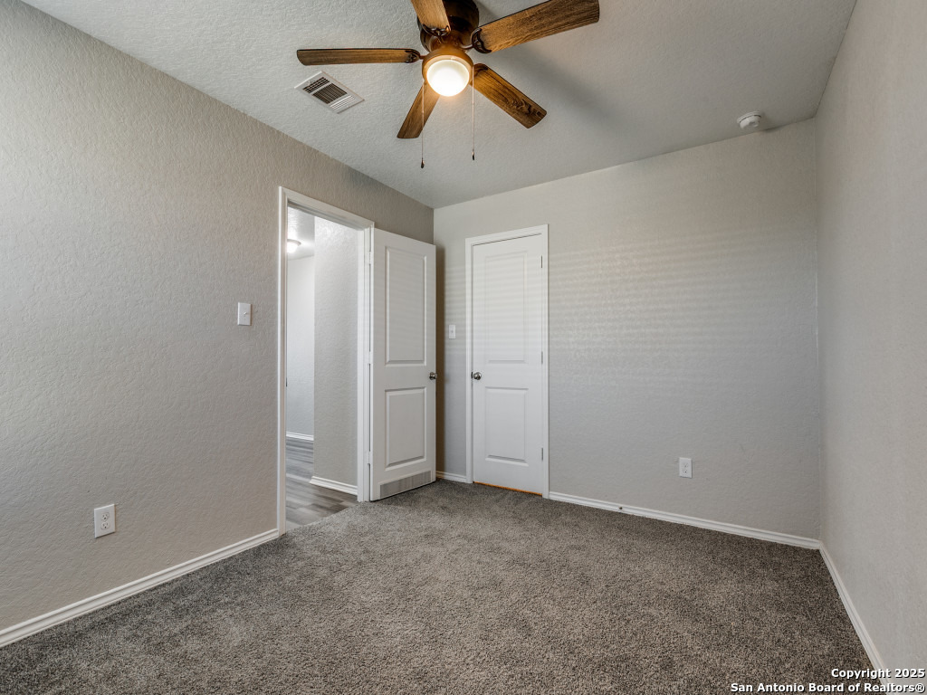 31593 Nimbus Drive Bulverde, TX 78163 - Photo 16 of 30 an empty room with chandelier fan