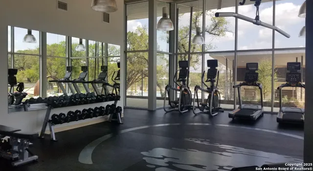 a view of a living room with furniture and floor to ceiling window