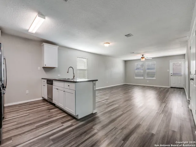 a kitchen with granite countertop a sink and window