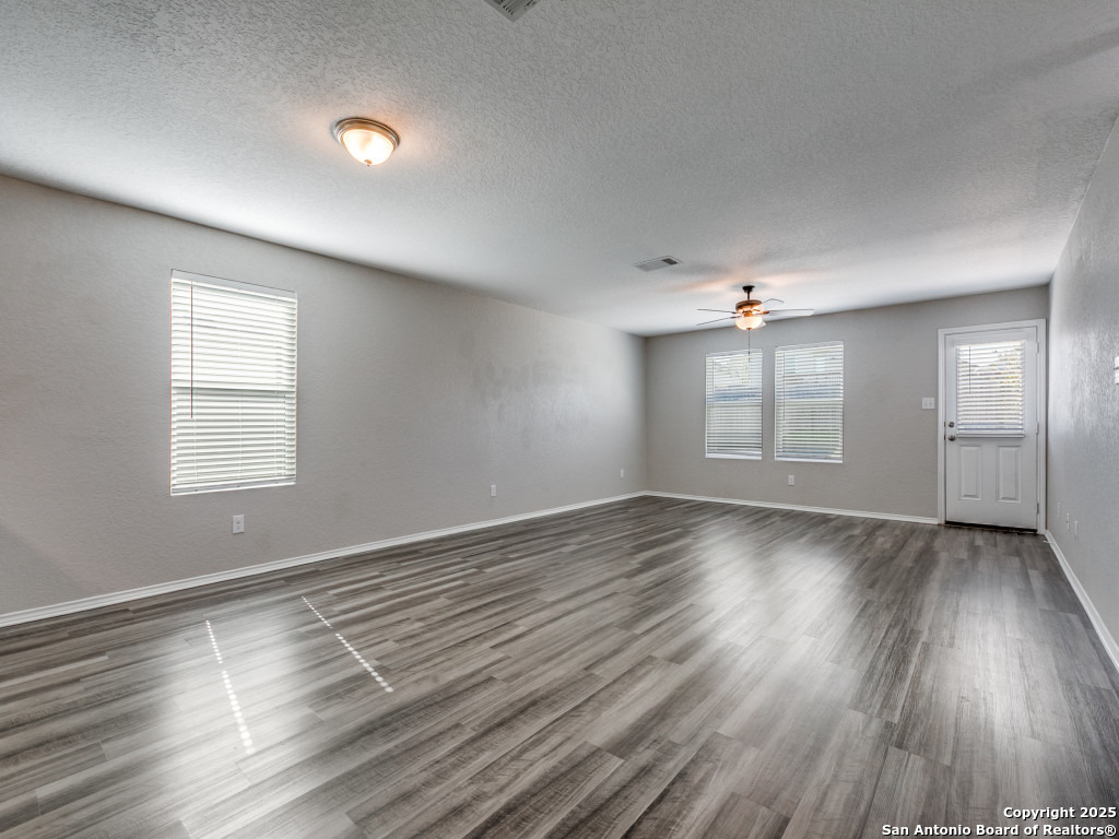 31593 Nimbus Drive Bulverde, TX 78163 - Photo 4 of 30 an empty room with wooden floor and windows