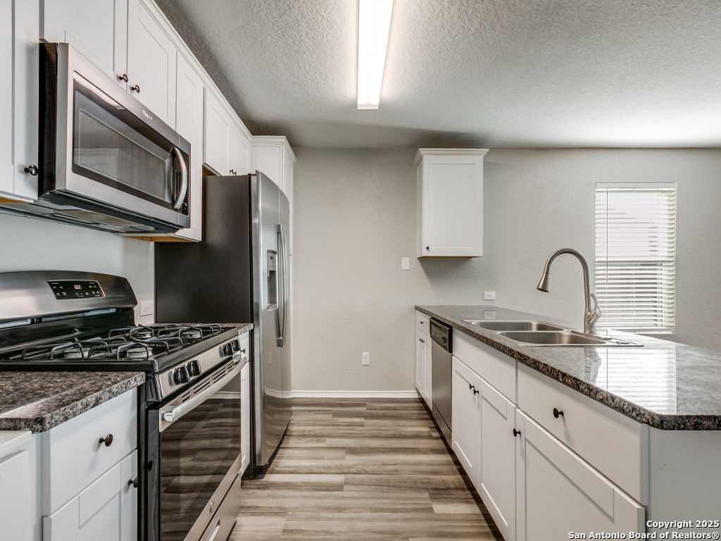 31593 Nimbus Drive Bulverde, TX 78163 - Photo 5 of 30 a kitchen with stainless steel appliances granite countertop a sink and a stove