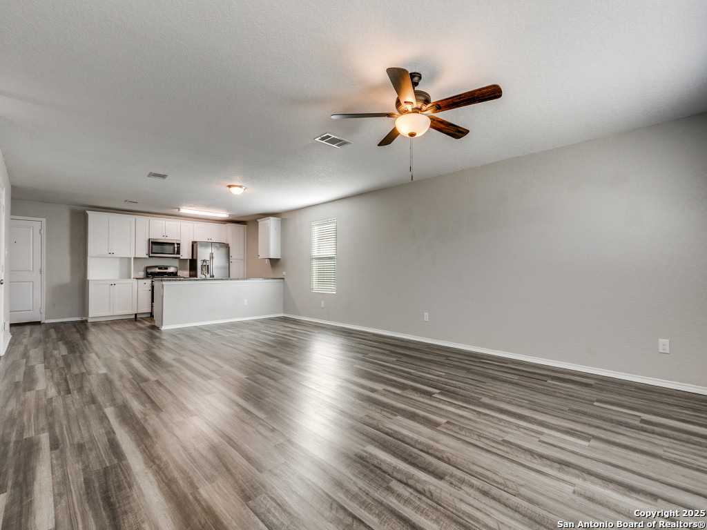31593 Nimbus Drive Bulverde, TX 78163 - Photo 9 of 30 a view of empty room with wooden floor and fan