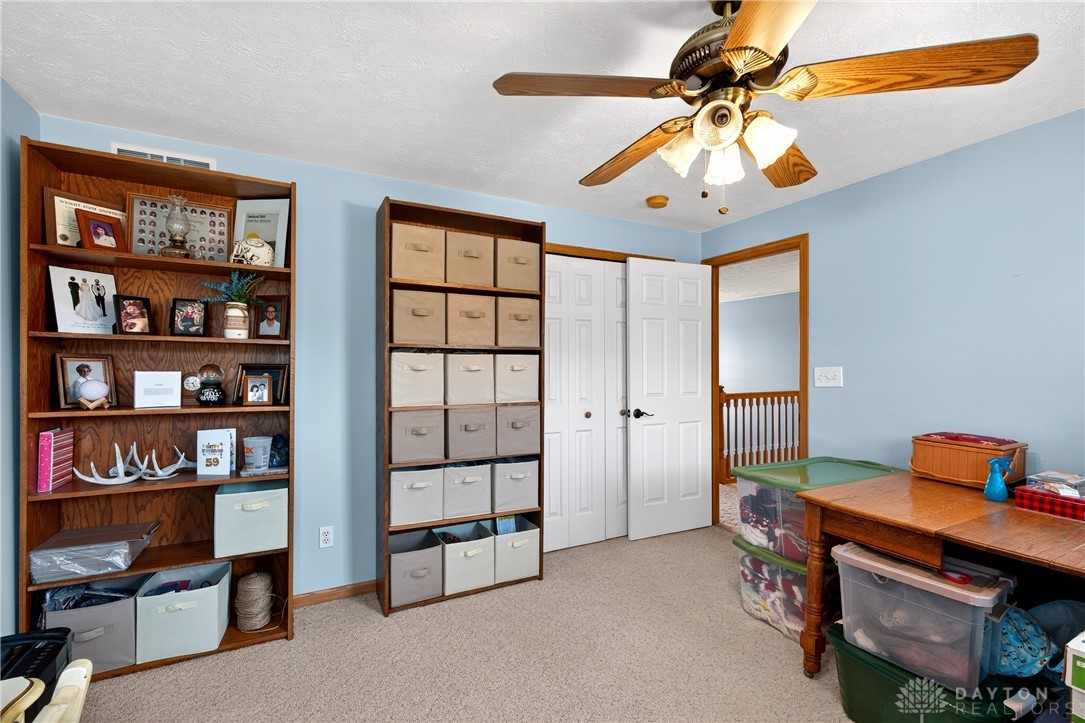 6560 Snyder Road Fletcher, OH 45326 - Photo 40 of 71 This spacious bedroom offers comfortable carpeting and a bright ceiling fan for optimal airflow.