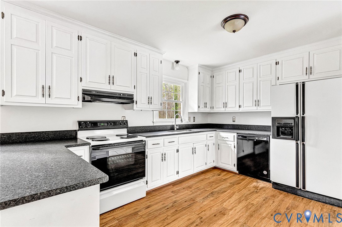 9107 Mossy Brook Road Mechanicsville, VA 23116 - Photo 7 of 30 Kitchen with dark countertops, electric stove, whi