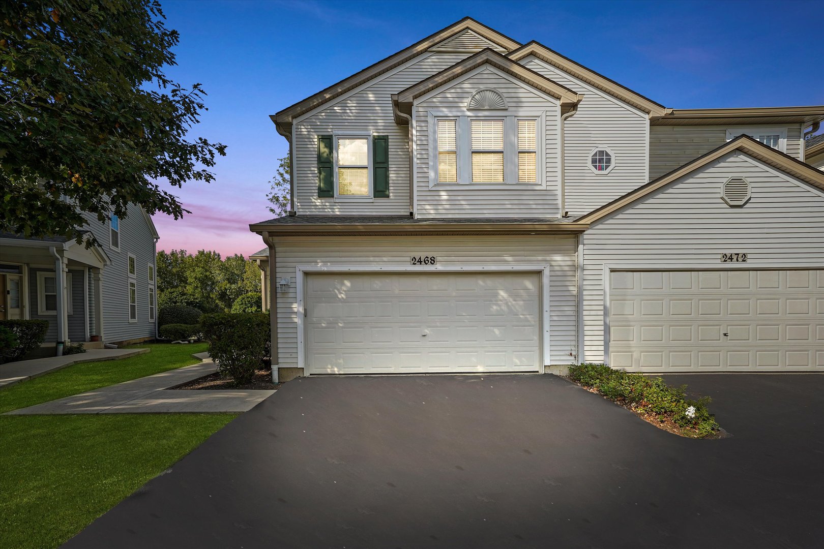 2468 Reflections Drive, Unit 2468 Aurora, IL 60502 - Photo 18 of 21 a front view of a house with a yard and garage
