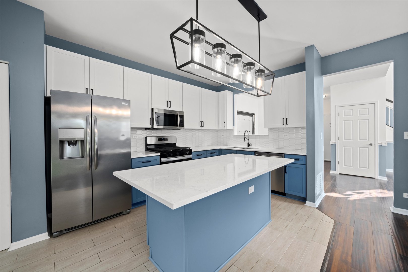 2468 Reflections Drive, Unit 2468 Aurora, IL 60502 - Photo 4 of 21 a large kitchen with stainless steel appliances kitchen island granite countertop a refrigerator a sink dishwasher a stove and a refrigerator with wooden floor