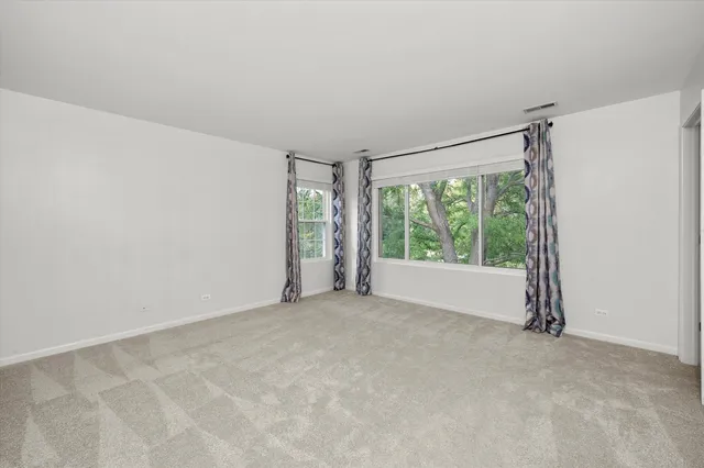 an empty room with large windows