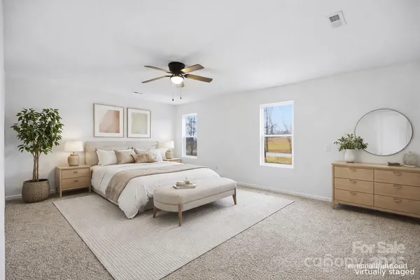 a bed room with bed and a chandelier