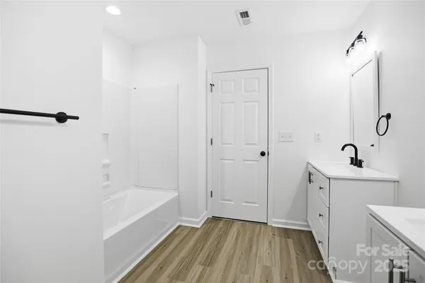 an empty room with windows and fan view