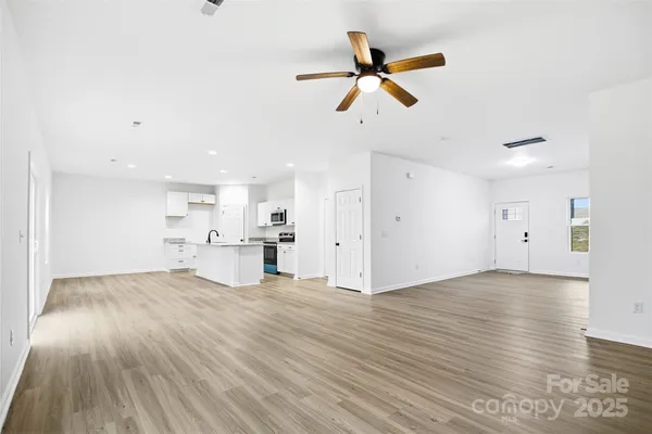 a kitchen with a sink window and stainless steel appliances