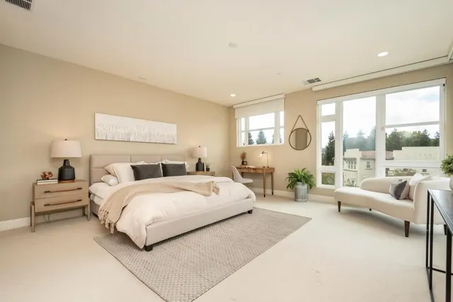 a bedroom with a large bed and a large window