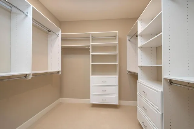 a bedroom with a bed lamp and a large window