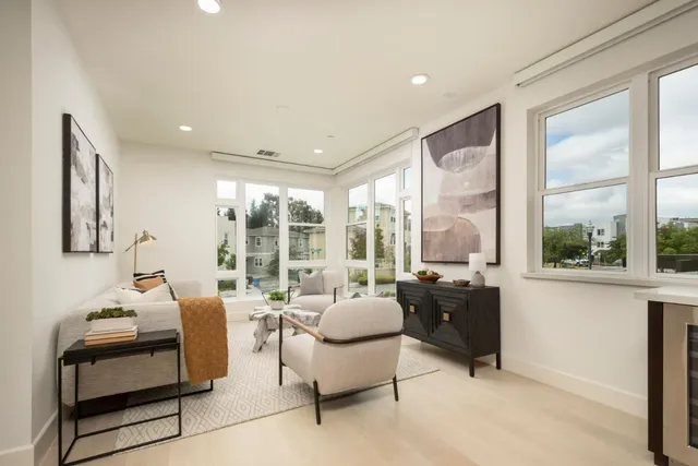 a living room with furniture fireplace and a large window