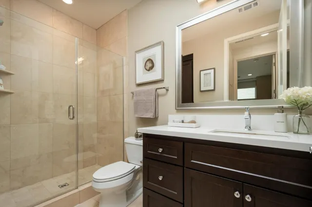 a spacious bedroom with a bed and large glass window