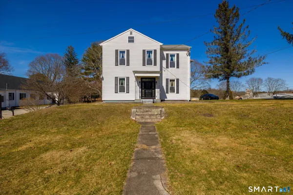 a front view of a house with a yard