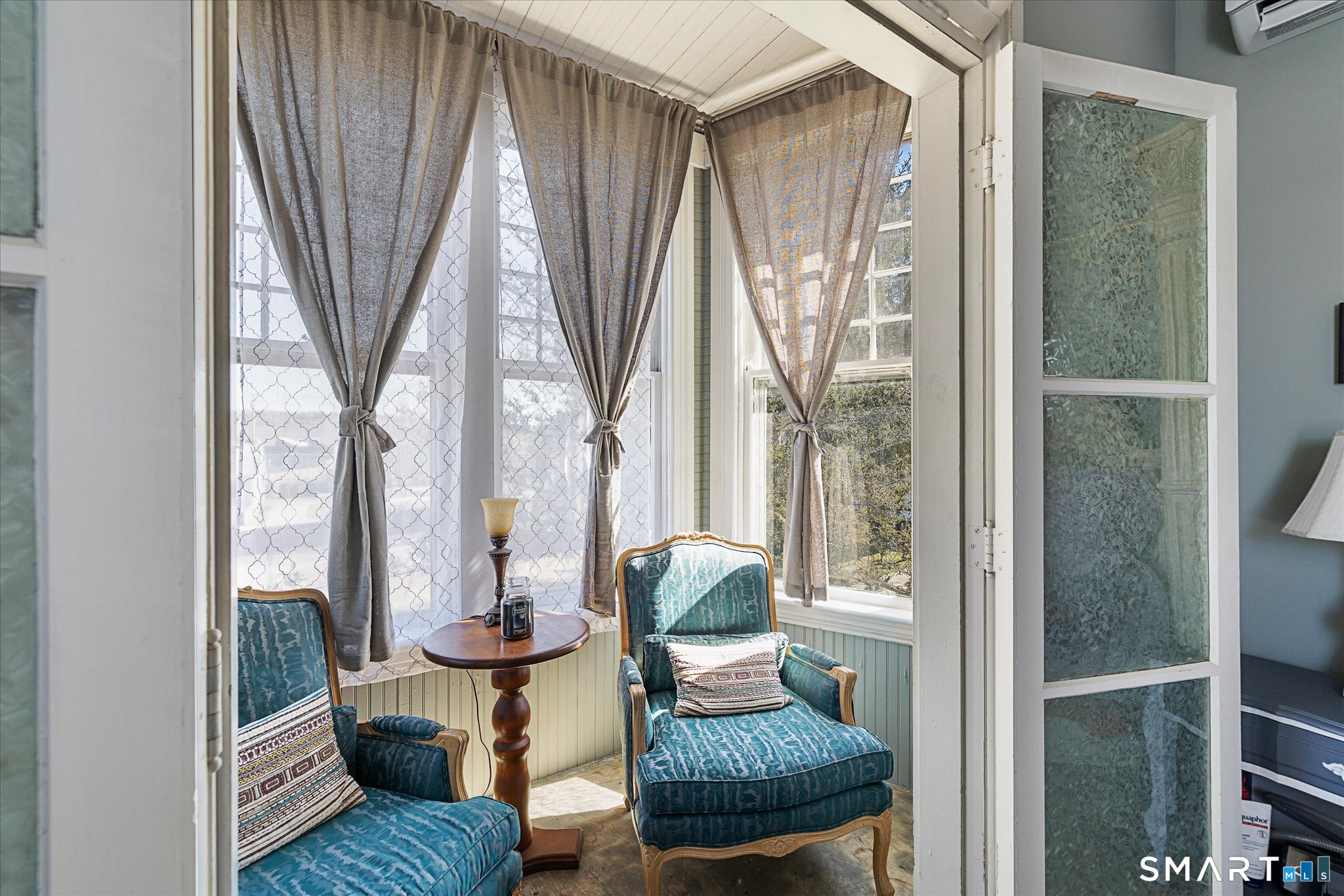 350 Hartford Pike Killingly, CT 06241 - Photo 11 of 32 a living room with large windows table and chairs