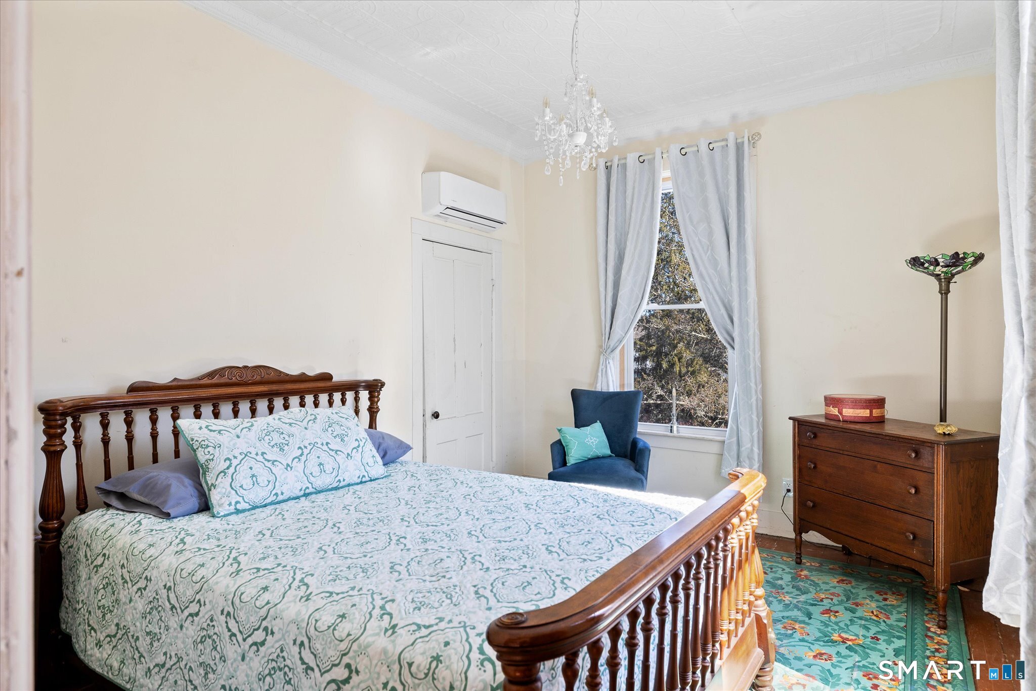 350 Hartford Pike Killingly, CT 06241 - Photo 15 of 32 a bedroom with a bed and a chandelier