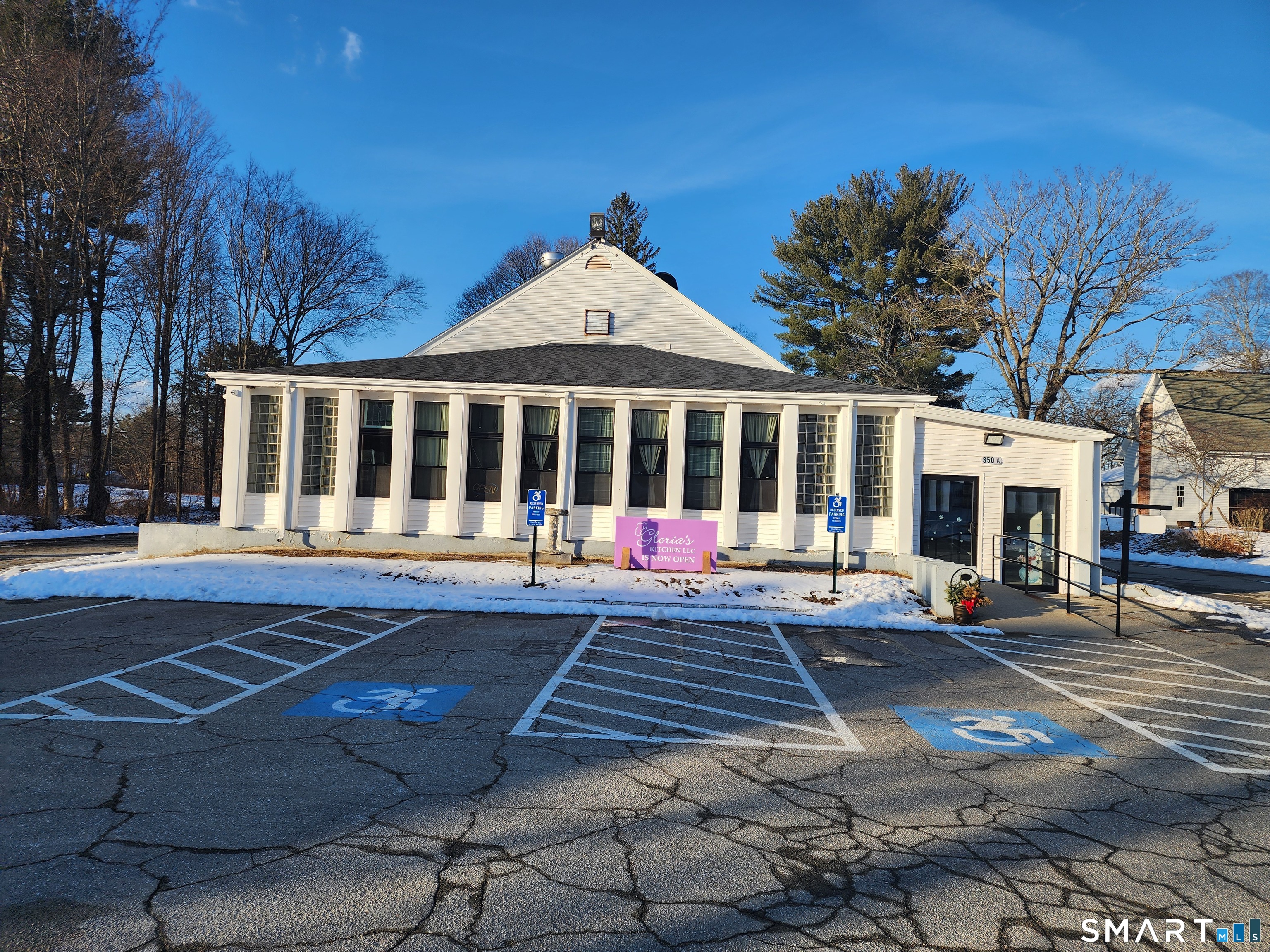 350 Hartford Pike Killingly, CT 06241 - Photo 16 of 32 a view of a white house with a large windows and a yard