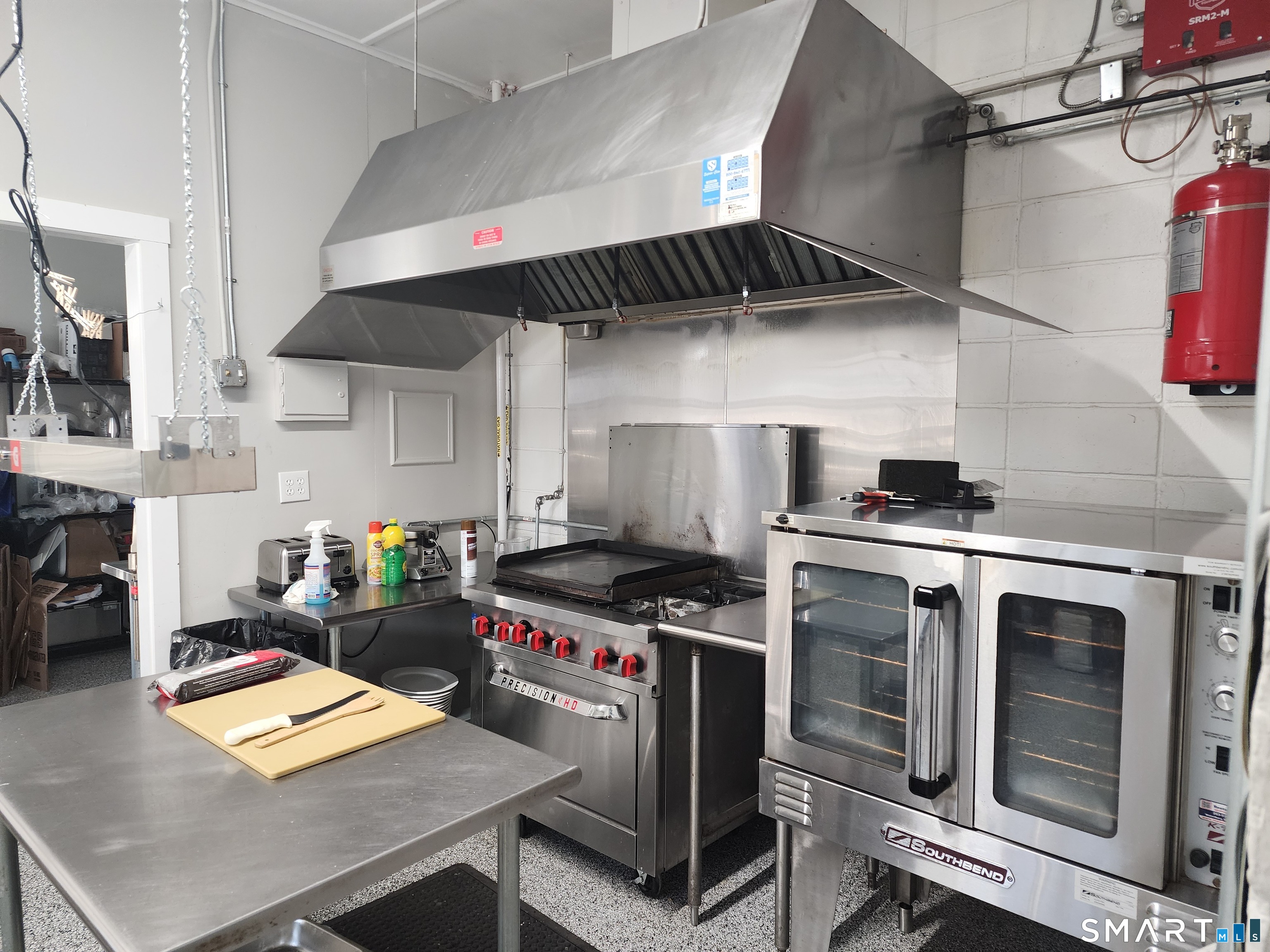 350 Hartford Pike Killingly, CT 06241 - Photo 18 of 32 a kitchen with stainless steel appliances a stove a sink dishwasher and cabinets with wooden floor