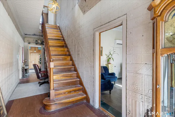 a kitchen with stainless steel appliances granite countertop a refrigerator a stove and a sink