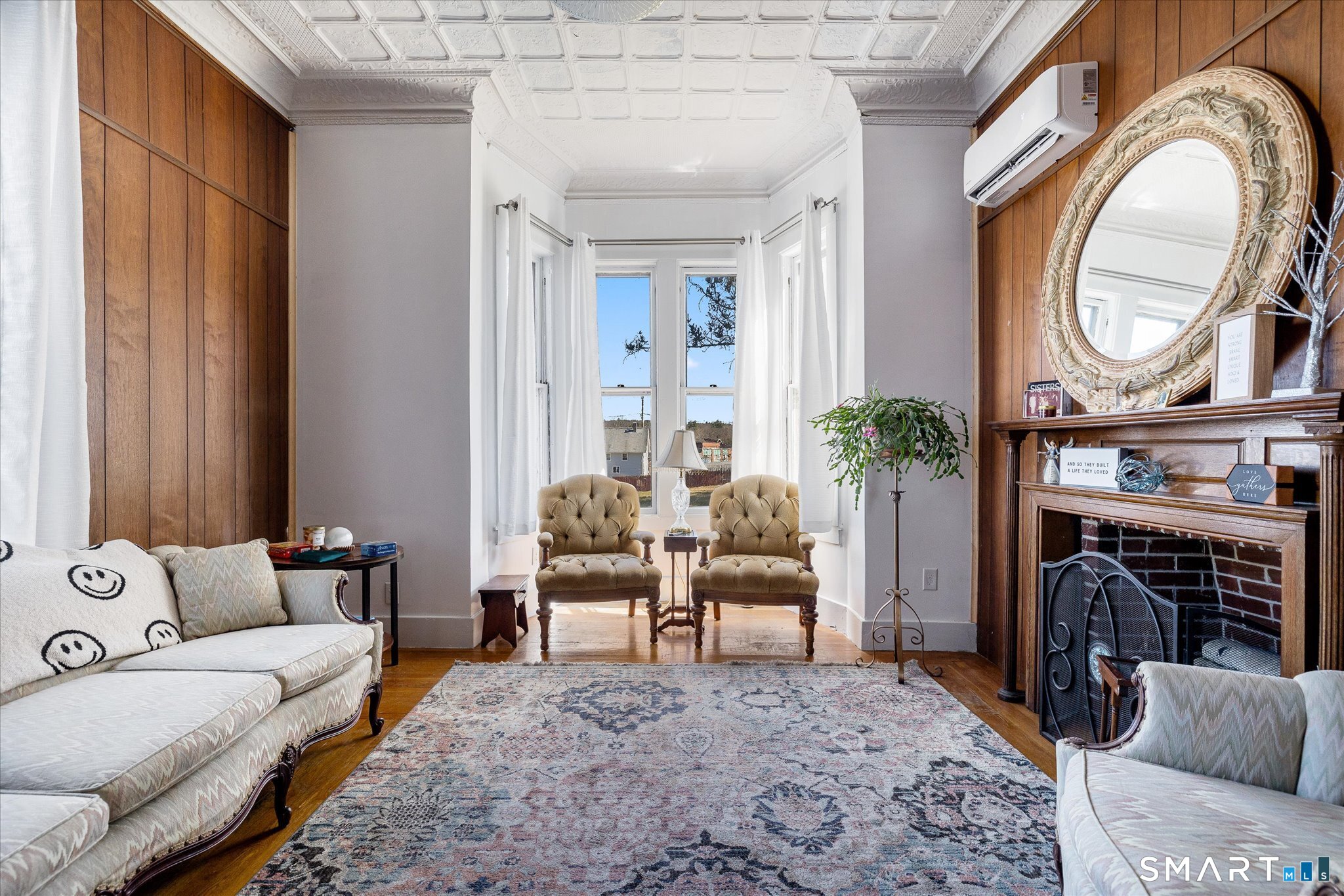 350 Hartford Pike Killingly, CT 06241 - Photo 4 of 32 a living room with furniture a fireplace and a large mirror