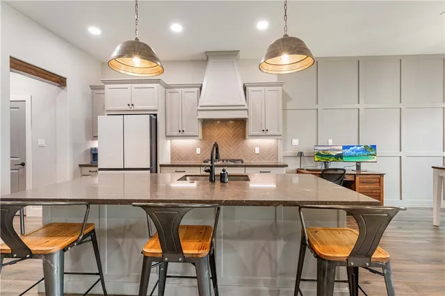 a kitchen with kitchen island granite countertop a table and chairs in it