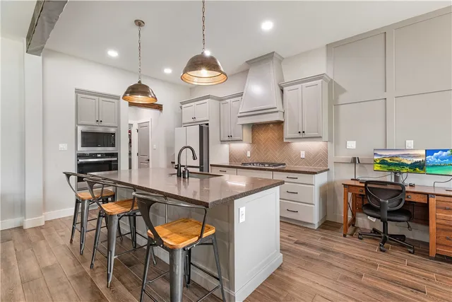 a large kitchen with a table and chairs in it