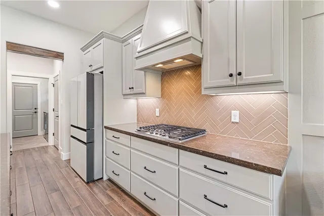 a kitchen with cabinets and a stainless steel appliances