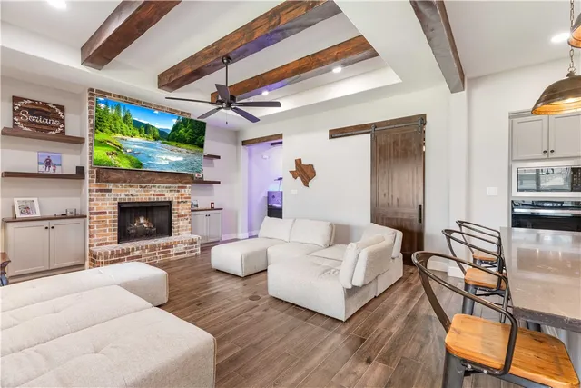 a living room with furniture a flat screen tv and a fireplace