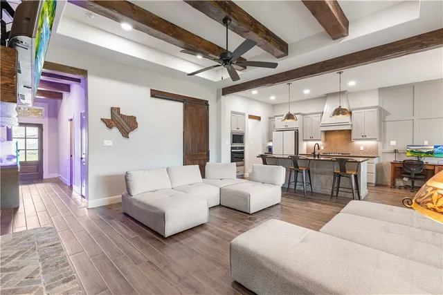 a living room with furniture and a chandelier