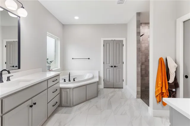 a bathroom with a double vanity sink and a mirror