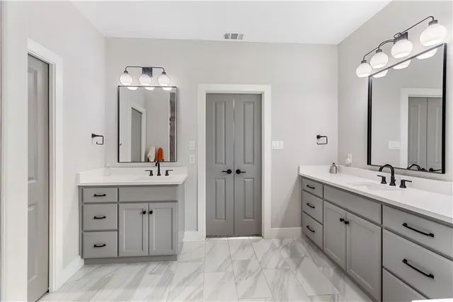 a spacious bathroom with a double vanity sink mirror and