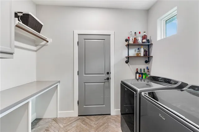 a utility room with cabinets washer and dryer