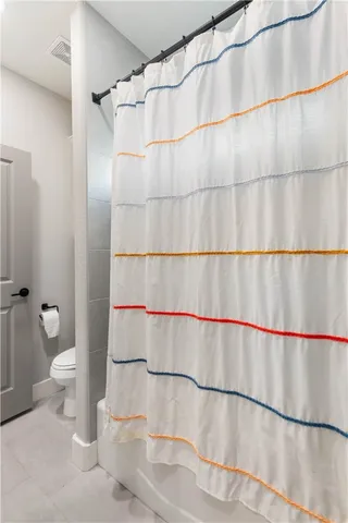 a bathroom with a shower and a toilet