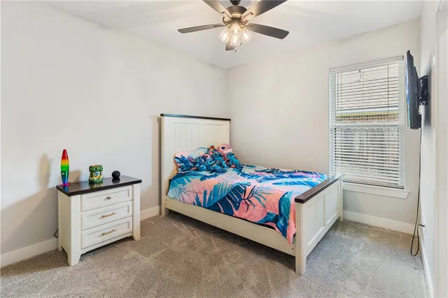 a bedroom with a bed and a dresser in it