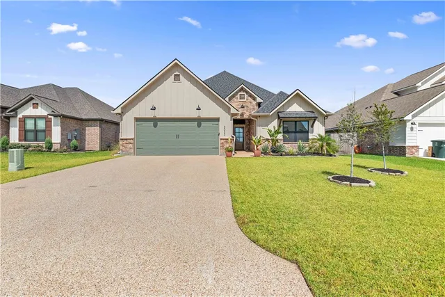 a view of a house with a big yard and large trees