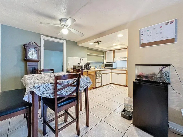 a large kitchen with kitchen island a large counter space a sink appliances and living room view