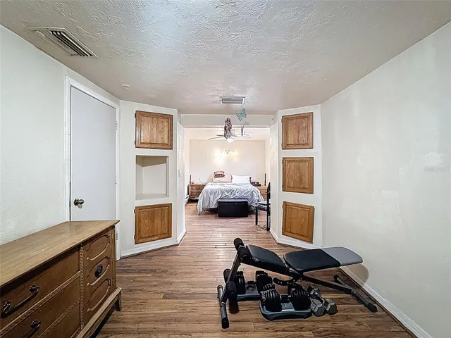 a bedroom with furniture and a dresser