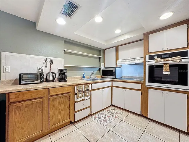 a refrigerator freezer sitting in a kitchen with a refrigerator