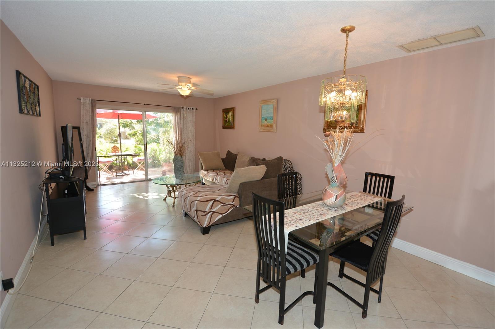 8936 Belle Aire Court, Unit 375 Boca Raton, FL 33433 - Photo 9 of 32 a view of a dining room with furniture wooden floor and chandelier