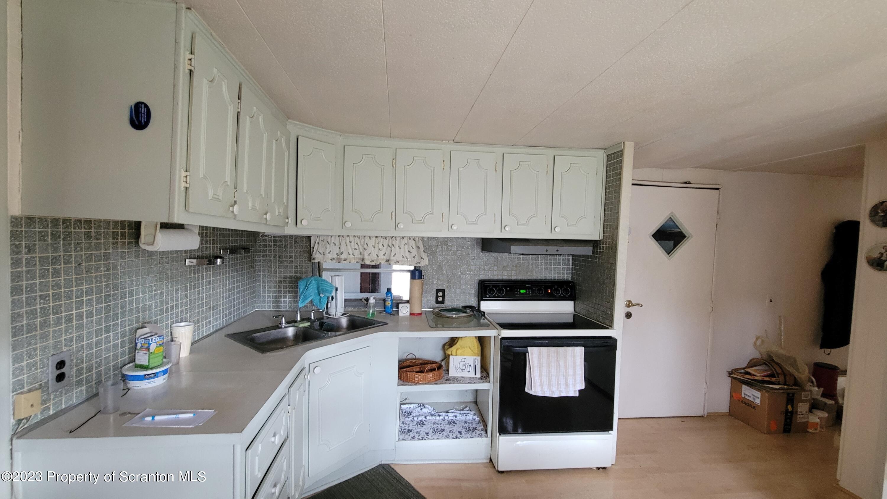 64 Franklin Street Great Bend, PA 18821 - Photo 11 of 17 a kitchen with stainless steel appliances a stove a sink a refrigerator a microwave and cabinets
