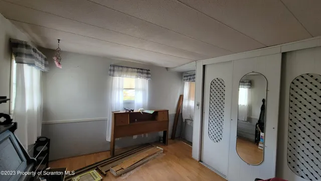 a view of a hallway with workspace and a mirror