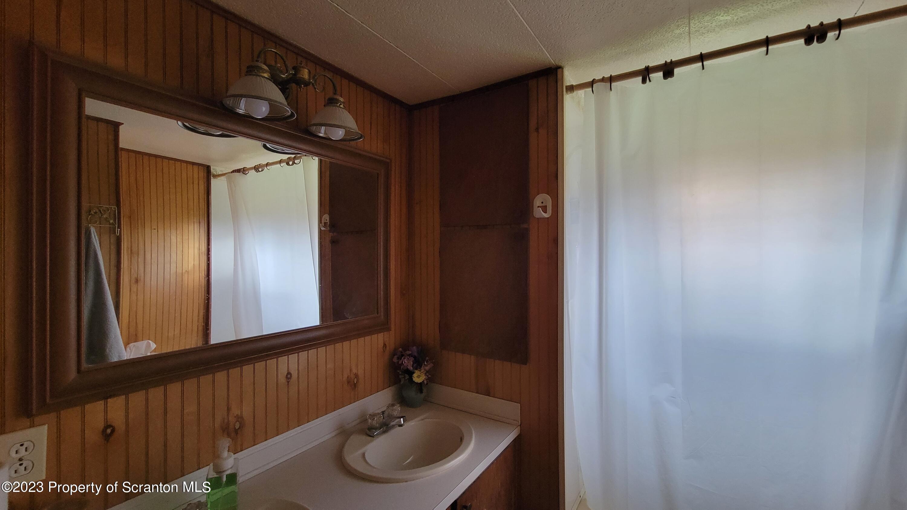 64 Franklin Street Great Bend, PA 18821 - Photo 15 of 17 a bathroom with a sink and a mirror