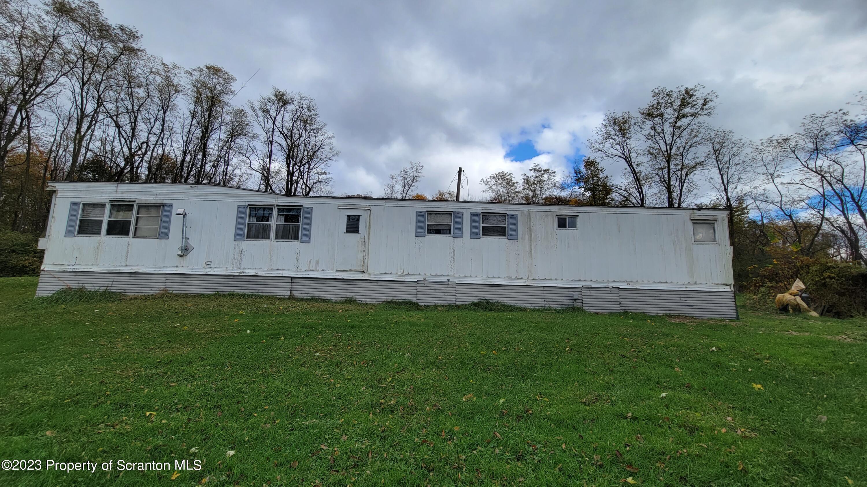 64 Franklin Street Great Bend, PA 18821 - Photo 3 of 17 a backyard of a house with lots of green space