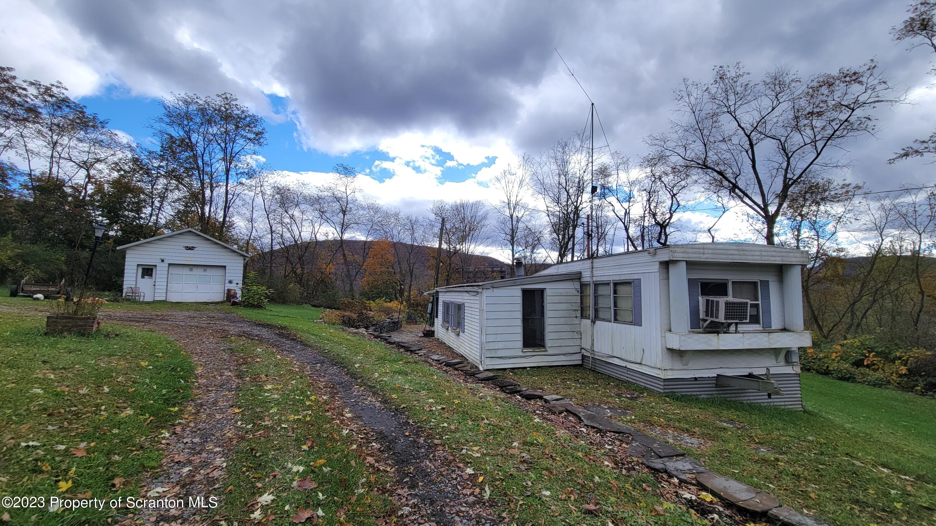 64 Franklin Street Great Bend, PA 18821 - Photo 6 of 17 a view of a house with backyard and garden
